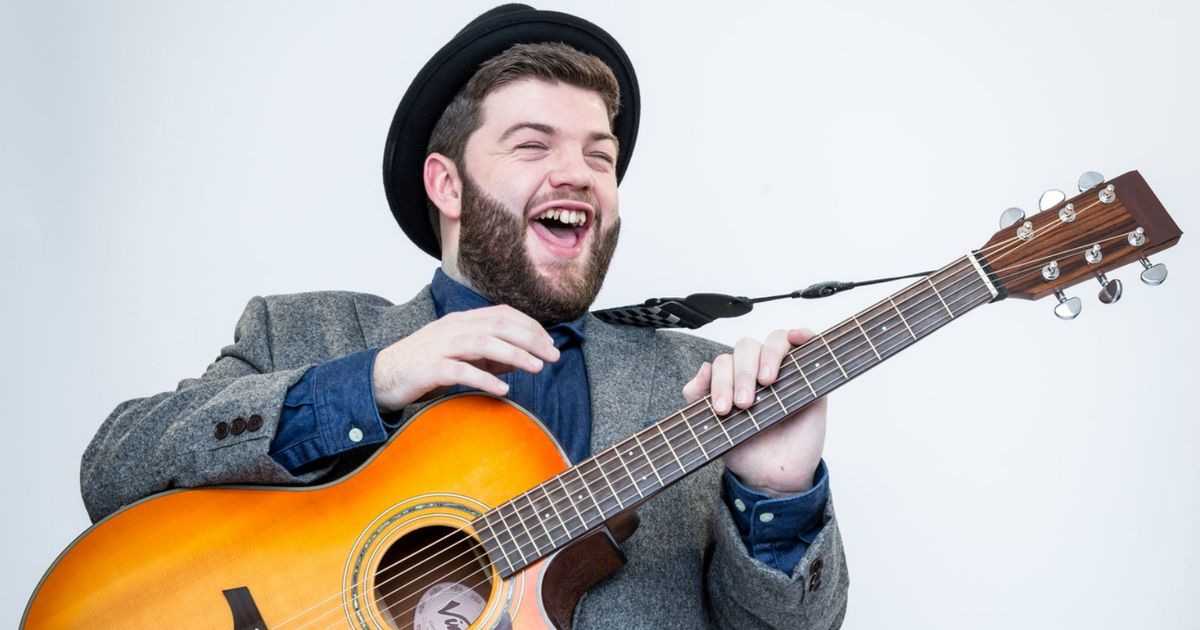 Tobias Robertson with acoustic guitar