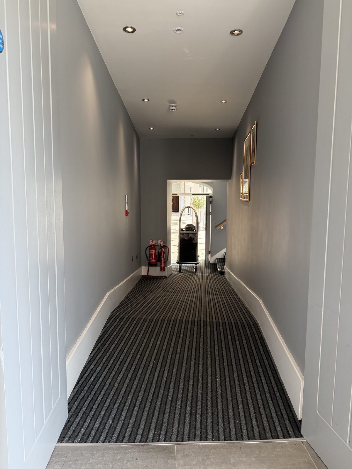 The ramp down from the corridor, with the courtyard door at the end of it